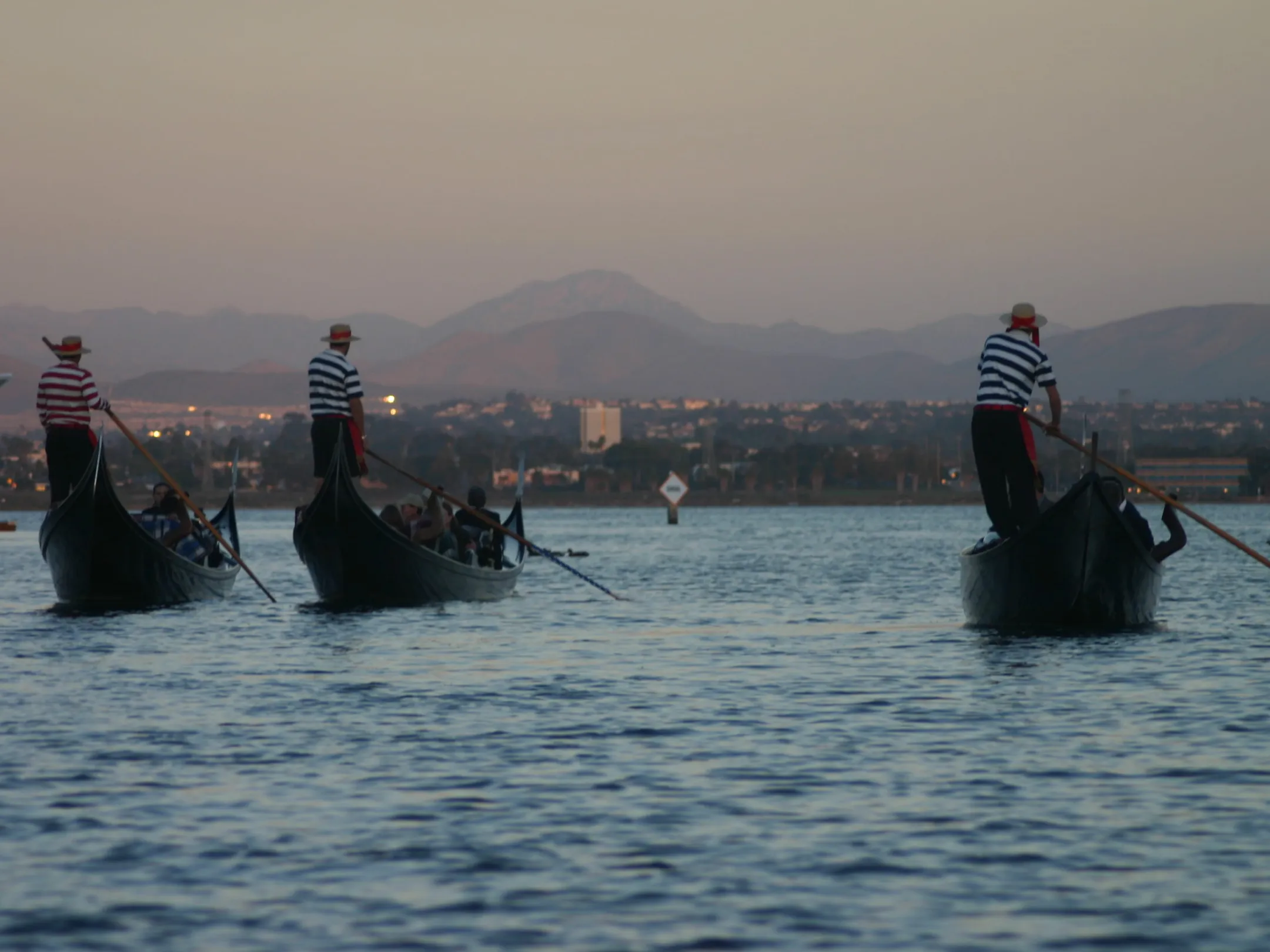 a group of people in a small boat in a body of water