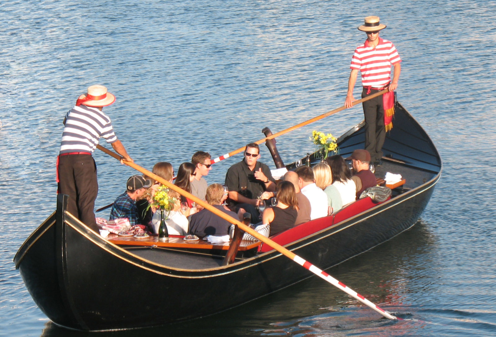 a group of people in a small boat in a body of water