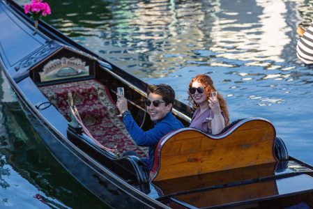 A couple on a gondola toasting to romance on the romantic gondola cruise in San Diego
