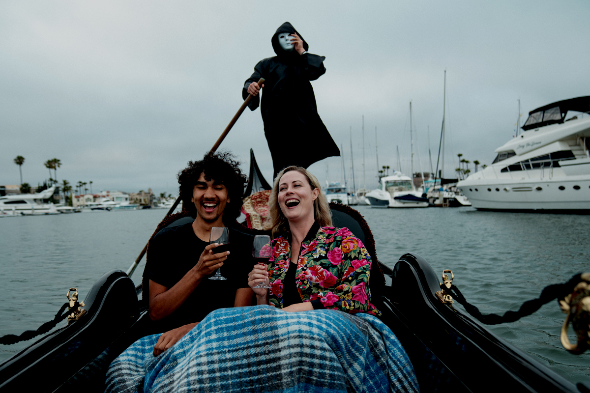 A Haunting In Venice San Diego a woman sitting on a gondola on the water