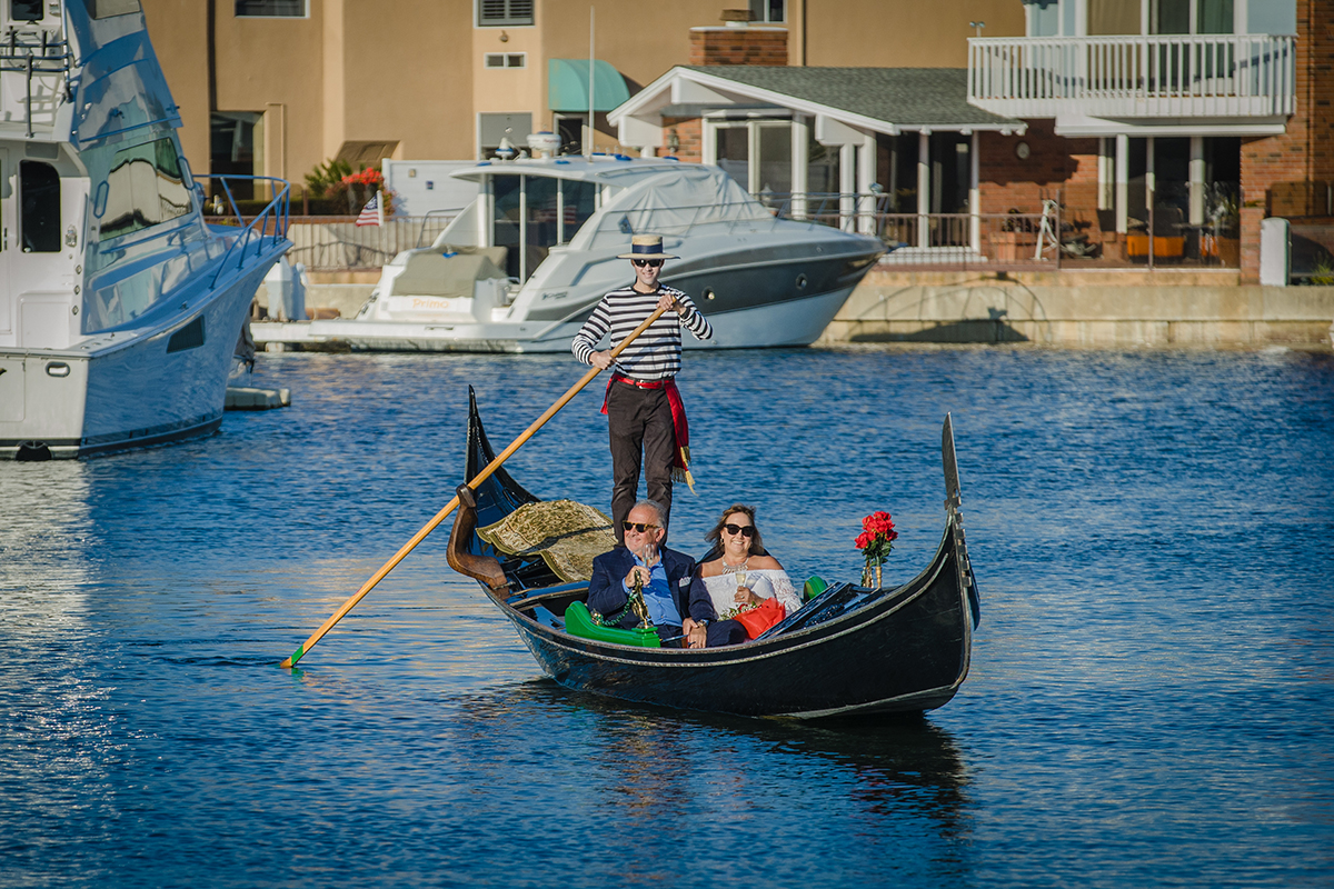 a couple riding on the back of a boat in the water