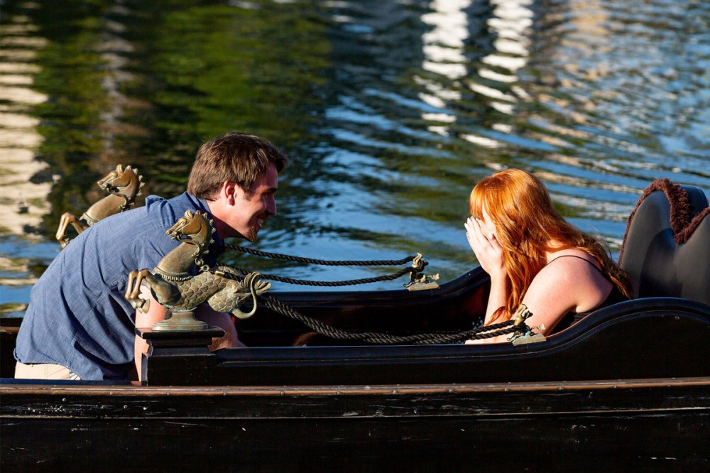 Couple sharing a romantic gondola proposal on the waters of Coronado in San Diego.