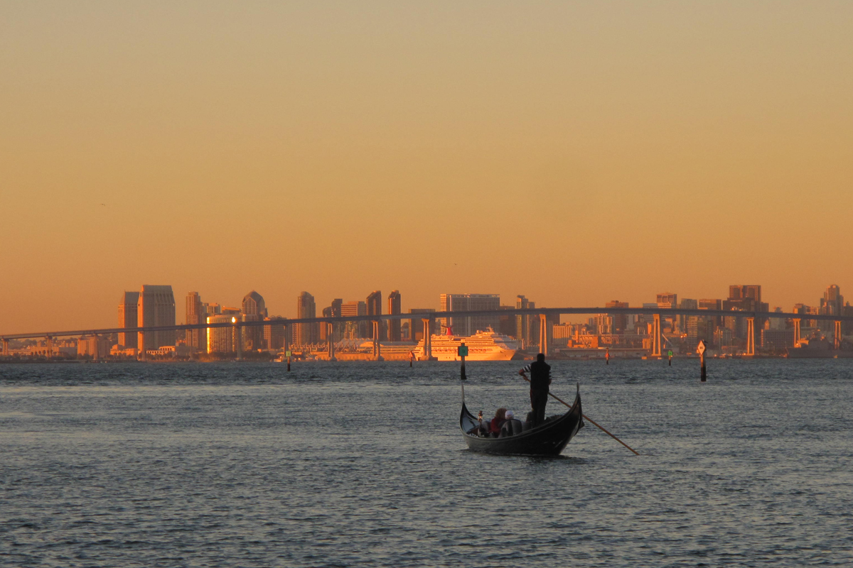 Gondola at sunset with the downtown San Diego skyline in the background.