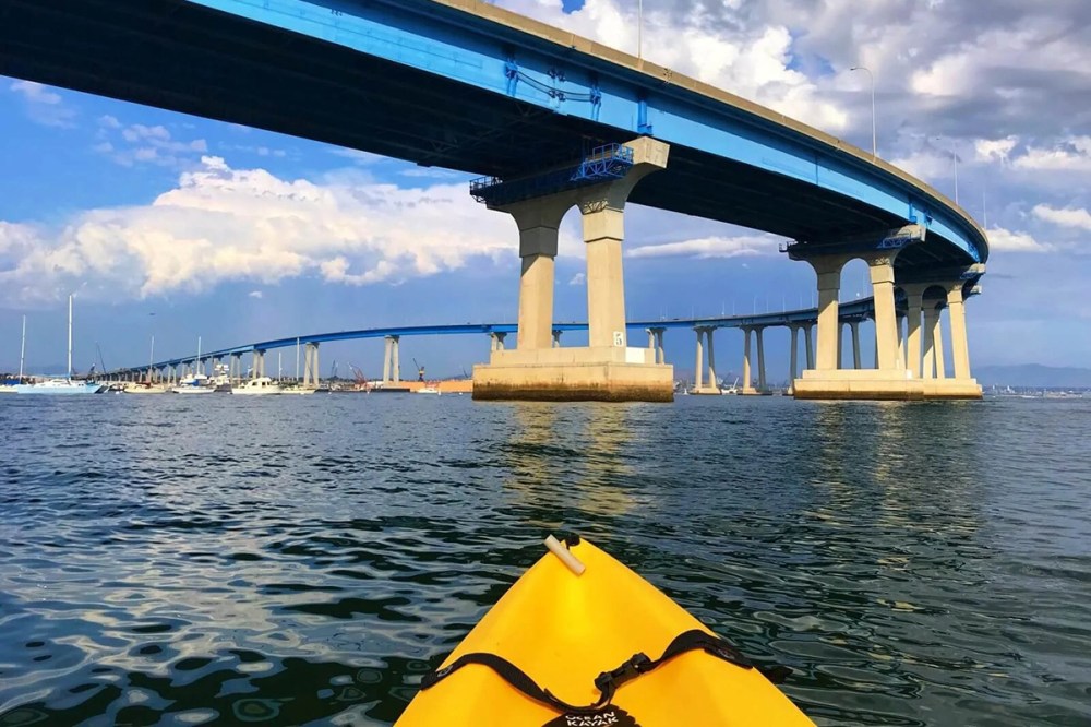Kayaking under the Coronado Bridge with views of San Diego Bay and skyline