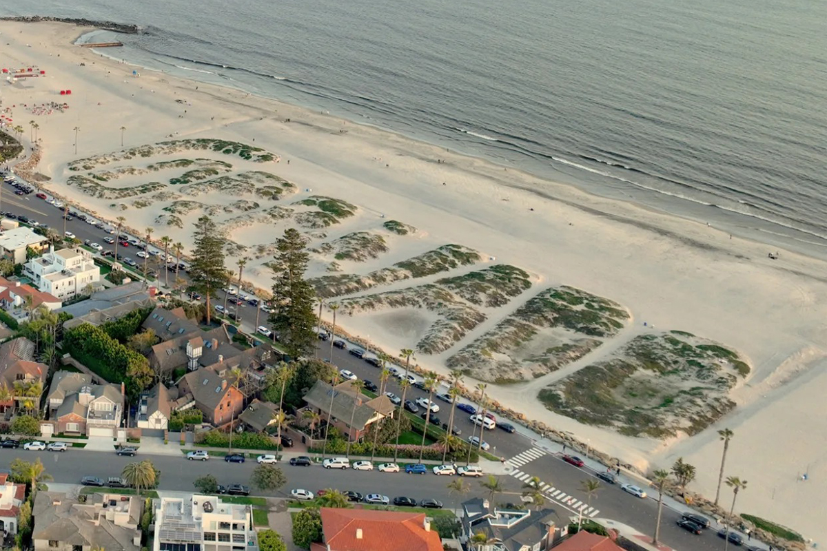 Coronado sand dunes message near Hotel del Coronado on Coronado Beach at sunset