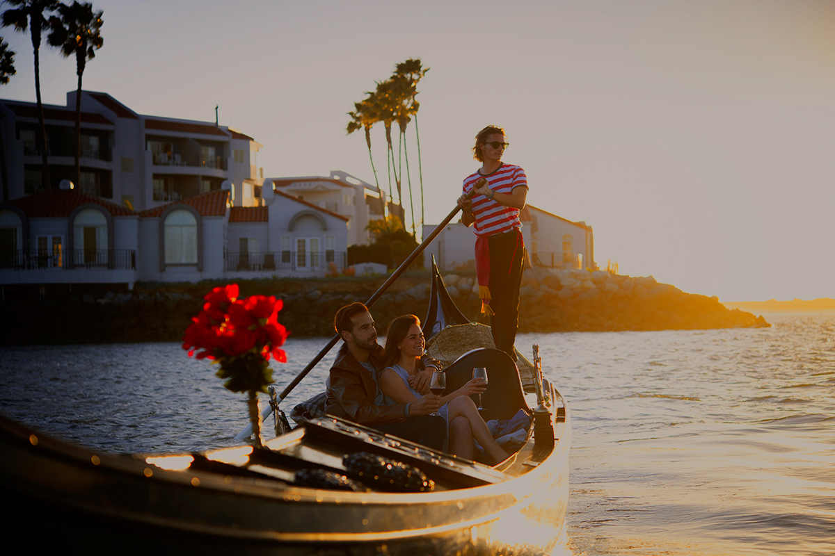 A couple enjoying gondola ride at sunset from the Loews Coronado Bay Resort.