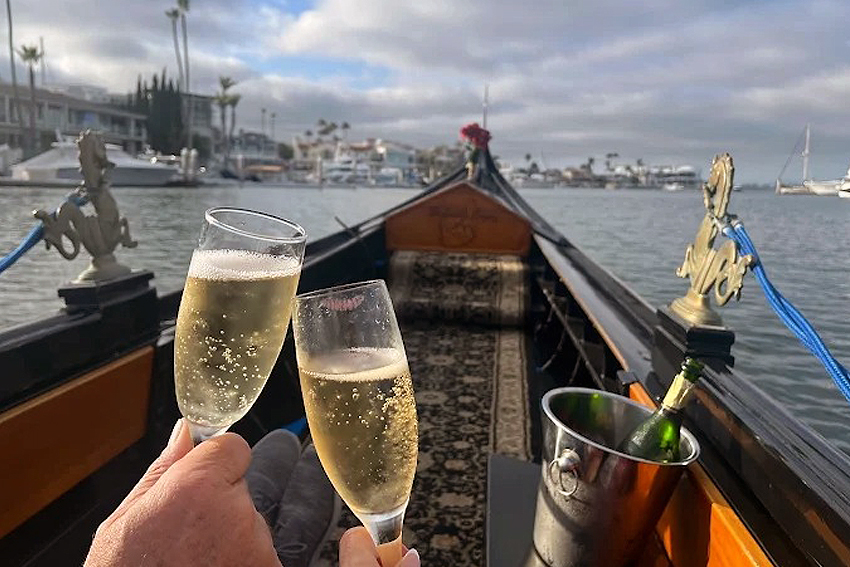 Mom and Dad celebrating Father’s Day on a gondola ride in Coronado clinking champagne glasses on a gondola in Coronado.