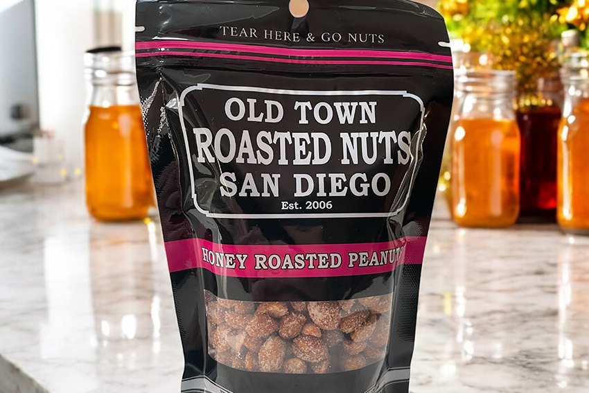 Bag of honey roasted peanuts on a marble counter.