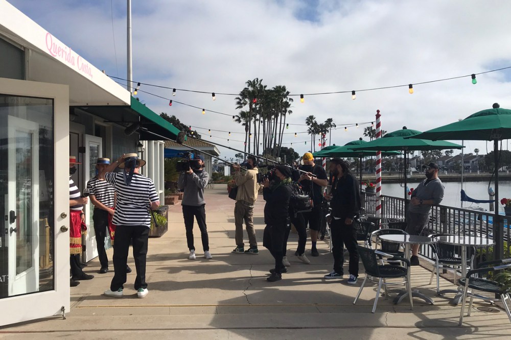 Videographer and film crew filming gondoliers for a music video or photoshoot