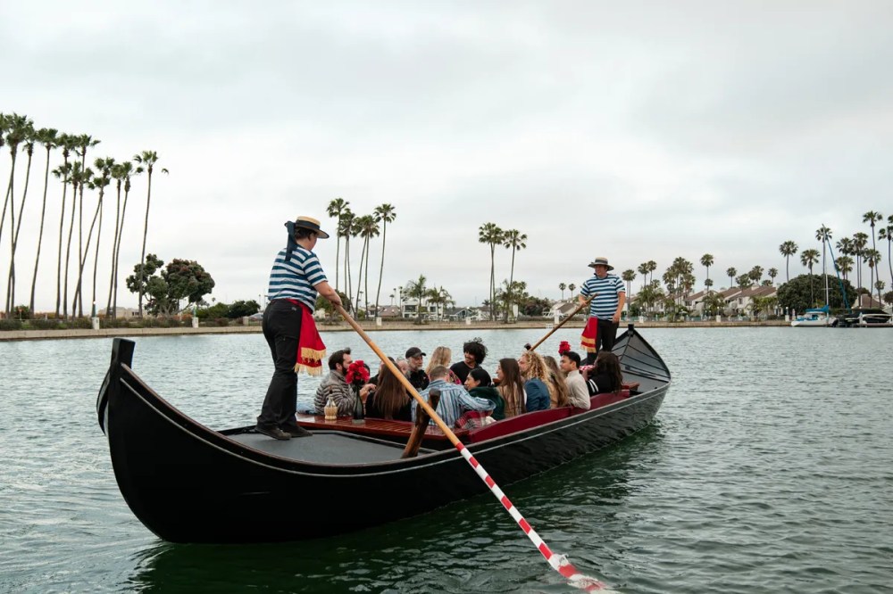 A large 14-passenger Venetian gondola carrying a group celebration through the calm waters of the Coronado Cays in San Diego